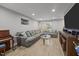 Spacious living room with laminate floors, piano, and recessed lighting at 112 Autumn Ridge Dr, Knightdale, NC 27545