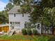 Exterior view of the house with a porch, fenced yard, surrounded by mature trees at 112 Autumn Ridge Dr, Knightdale, NC 27545
