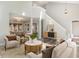 Open-concept living room with a fireplace, soaring ceilings, and wood-look flooring and modern decor at 112 Solstice Cir, Cary, NC 27513