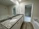 Bathroom featuring double sinks with granite countertops and white cabinetry at 116 Oakfield Trace Dr, Four Oaks, NC 27524