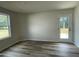 Bright bedroom with modern flooring, a window providing natural light, and a neutral color scheme at 116 Oakfield Trace Dr, Four Oaks, NC 27524