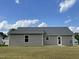Back exterior of home showing neutral siding, gray roof and a large backyard at 116 Oakfield Trace Dr, Four Oaks, NC 27524