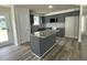 Modern kitchen with granite countertops, stainless steel appliances, a kitchen island, and gray cabinetry at 116 Oakfield Trace Dr, Four Oaks, NC 27524