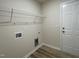 Functional laundry room with shelving, connections for a washer and dryer, and a door to the exterior at 116 Oakfield Trace Dr, Four Oaks, NC 27524