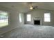 Spacious living room with a cozy fireplace, vaulted ceiling, and multiple windows for natural light at 116 Oakfield Trace Dr, Four Oaks, NC 27524