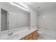 Well-lit bathroom with double sink vanity, large mirror, and shower over tub at 117 Drakewood Pl, Cary, NC 27518