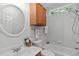 Well-lit bathroom featuring a vanity with white sink, a medicine cabinet, and a bathtub/shower combo at 117 Drakewood Pl, Cary, NC 27518