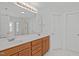 Bathroom featuring double sinks, large mirror and light wood vanity at 117 Drakewood Pl, Cary, NC 27518