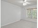 Empty bedroom features neutral colored walls and carpet, along with a large window at 117 Drakewood Pl, Cary, NC 27518