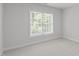 A view of an empty bedroom featuring a window for natural light at 117 Drakewood Pl, Cary, NC 27518