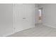 Bright bedroom featuring neutral carpet, fresh paint, and closet with double doors at 117 Drakewood Pl, Cary, NC 27518