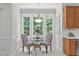 Charming breakfast nook with a glass table, upholstered chairs, and a view of the outdoors at 117 Drakewood Pl, Cary, NC 27518