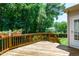 Spacious deck with wooden railings, ideal for entertaining with serene backyard views at 117 Drakewood Pl, Cary, NC 27518
