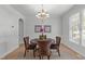 Elegant dining room with hardwood floors, chandelier, and wainscoting with a round table at 117 Drakewood Pl, Cary, NC 27518