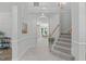 Spacious foyer with staircase, arched doorway, tile floor, and neutral paint, creating a grand entrance at 117 Drakewood Pl, Cary, NC 27518