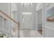 Bright foyer with high ceilings, neutral paint, tile flooring, and white front door with sidelights at 117 Drakewood Pl, Cary, NC 27518