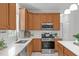 Spacious kitchen features white countertops, stainless steel appliances, wood cabinets and subway tile backsplash at 117 Drakewood Pl, Cary, NC 27518