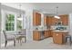 Bright, well-equipped kitchen featuring wood cabinets, stainless steel appliances, and eat in breakfast nook at 117 Drakewood Pl, Cary, NC 27518