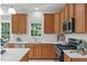 Charming kitchen with white countertops, stainless steel appliances, and wood cabinets at 117 Drakewood Pl, Cary, NC 27518