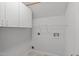 Functional laundry room featuring overhead cabinets and available hookups at 117 Drakewood Pl, Cary, NC 27518