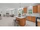 Open concept featuring modern kitchen, stainless appliances, stone countertops, island and breakfast bar at 117 Drakewood Pl, Cary, NC 27518