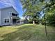 Lush backyard showcasing a well-maintained lawn, mature trees, and the home's exterior with deck and screened-in porch at 118 Chestnut St, Durham, NC 27707
