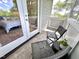 Outdoor balcony with dark wicker furniture and view back into the bedroom at 118 Chestnut St, Durham, NC 27707