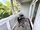 Covered balcony with dark wicker furniture at 118 Chestnut St, Durham, NC 27707