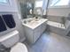 Modern bathroom with double vanity, quartz countertop, stylish tiling, and a separate shower and tub at 118 Chestnut St, Durham, NC 27707