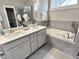 Modern bathroom featuring a double vanity, soaking tub, and tiled walls at 118 Chestnut St, Durham, NC 27707