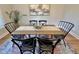 Cozy dining room showcasing an eye-catching painting and natural light from the window at 118 Chestnut St, Durham, NC 27707