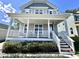 Inviting home exterior featuring a charming front porch, well-manicured landscaping, and welcoming curb appeal at 118 Chestnut St, Durham, NC 27707