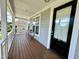 Inviting covered front porch with brown wood flooring and gray siding at 118 Chestnut St, Durham, NC 27707