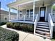 Charming front porch featuring white railing, stairs, and a gray exterior at 118 Chestnut St, Durham, NC 27707
