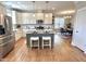 Spacious kitchen featuring white cabinets, an island with seating, and stainless steel appliances at 118 Chestnut St, Durham, NC 27707