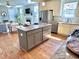 Open kitchen with island, granite counters, and stainless appliances flowing into the living area at 118 Chestnut St, Durham, NC 27707