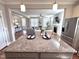 Open kitchen view to the living room with granite counters and stainless steel refrigerator at 118 Chestnut St, Durham, NC 27707