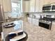 Granite countertops and stainless appliances accent this bright eat-in kitchen with a center island at 118 Chestnut St, Durham, NC 27707