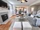 Open-concept living room featuring a fireplace and a view into the kitchen at 118 Chestnut St, Durham, NC 27707
