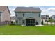 This home features a large backyard and exterior view of a screened porch and grill area at 1214 Valley Dale Dr, Fuquay Varina, NC 27526
