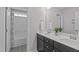 Stylish bathroom with double sink vanity, decorative mirrors, sleek fixtures, and a tub and shower combo at 1214 Valley Dale Dr, Fuquay Varina, NC 27526