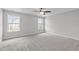 This bedroom features neutral walls, carpet, large windows, perfect for relaxation and comfort at 1214 Valley Dale Dr, Fuquay Varina, NC 27526