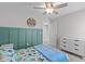This bedroom offers stylish wainscoting, neutral walls, and a ceiling fan for a comfortable living space at 1214 Valley Dale Dr, Fuquay Varina, NC 27526