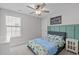 This bedroom features neutral walls, a ceiling fan, and a window with blinds that let in natural light at 1214 Valley Dale Dr, Fuquay Varina, NC 27526