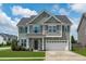 Charming two-story home featuring a manicured lawn and a two-car garage at 1214 Valley Dale Dr, Fuquay Varina, NC 27526