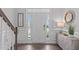 Bright foyer with wood floors, white trim and a view of the front door and stairway at 1214 Valley Dale Dr, Fuquay Varina, NC 27526