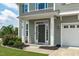 Inviting front entrance featuring elegant columns, lush landscaping and a dark-colored door at 1214 Valley Dale Dr, Fuquay Varina, NC 27526