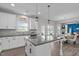 Open concept kitchen with granite counters, stainless appliances, and a view into the dining and living areas at 1214 Valley Dale Dr, Fuquay Varina, NC 27526