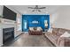 The living room features a bold accent wall, ceiling fan, and fireplace at 1214 Valley Dale Dr, Fuquay Varina, NC 27526