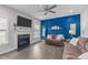Cozy living room features a fireplace, large TV, and comfortable sofas for relaxing and entertaining at 1214 Valley Dale Dr, Fuquay Varina, NC 27526